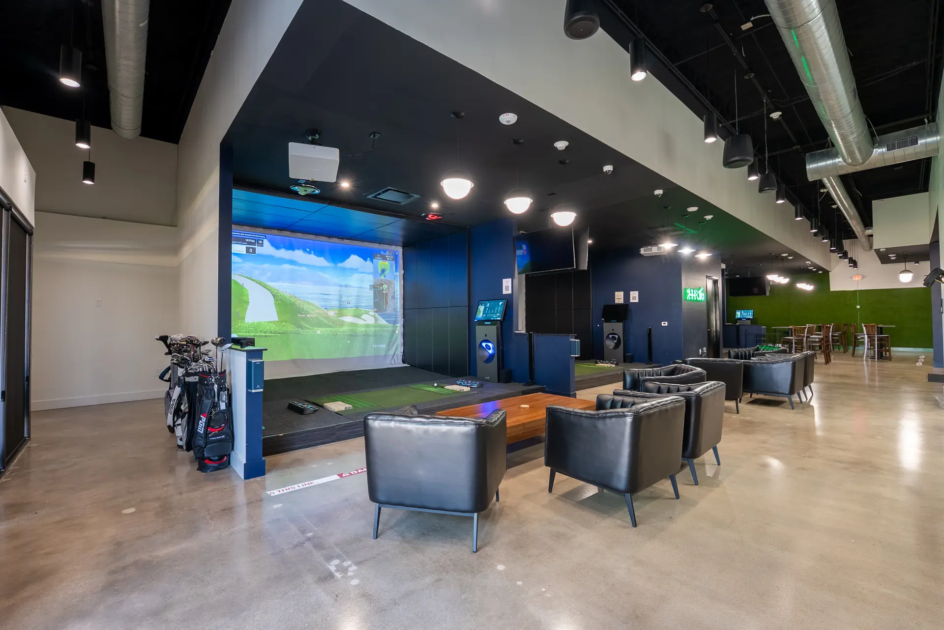 Lounge seating beside a 2-1-Fore simulator bay